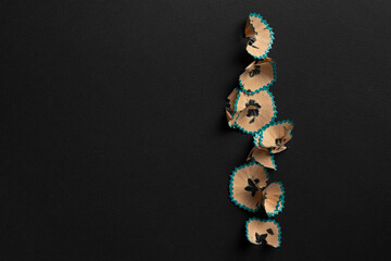 view from above of the sharpened pencil shavings on pastel background