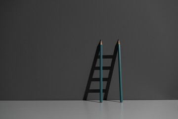pencil leaned on the wall and creating ladder made of shadow © Mihail