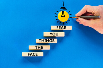 Face the things you fear symbol. Concept words Face the things you fear on wooden blocks on a...