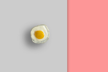 clean fried egg isolated on pastel background. minimalistic food concept