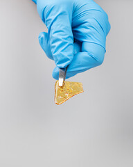 hand holding piece medical cannabis golden wax