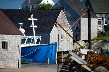 Fototapeta na wymiar Peggy's Cove fishing village, close-up on a boat with buildings in background