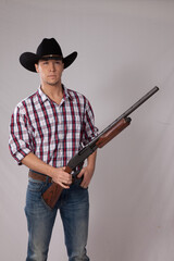 Handsome western man with a shotgun