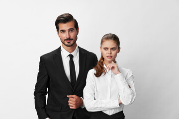 Man and woman anger business in business at each other shouting with their hands up in the air against a white isolated background. The concept of business in a couple harassment startup copy space