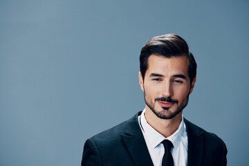 Portrait of business man with phone conversation and on blue background in business suit. Business portrait of a stylish man copy space