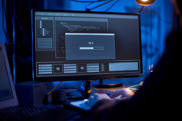 cybercrime, hacking and technology concept - close up of male hacker in dark room writing code or...