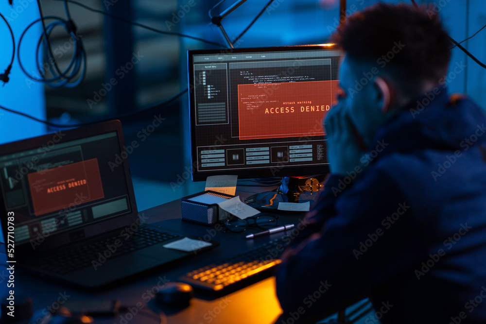 Poster cybercrime, hacking and technology concept - male hacker in dark room using computer virus program f