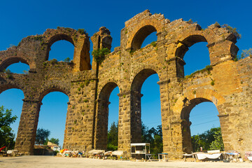 Fototapeta na wymiar Scenic view of ruins of antique Aspendos Aqueduct, one of most impressive water conveyance structures remaining from Roman era in Turkiye