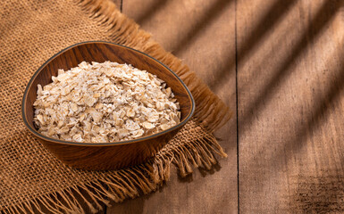 Avena sativa - Oat flakes in the wooden bowl