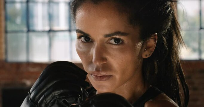 Strong, power and serious mma woman, fighter and boxer ready to punch, impact and self defense gym workout, challenge exercise and training. Portrait face of fitness, boxing gloves and sports athlete