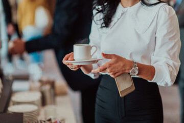 Close-up photo of businesswoman serving themselves in a modern hotel during a dinner party....
