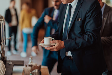Close-up photo of businessmen serving themselves in a modern hotel during a dinner party. Selective focus 