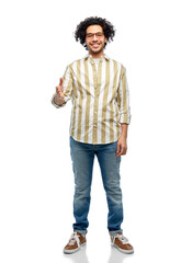 people and fashion concept - happy smiling man in glasses giving hand for handshake over white background