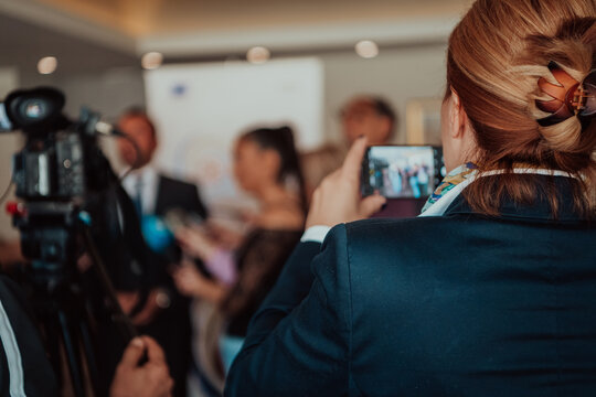 professional video production camera recording live event on stage. television social media broadcasting seminar conference.