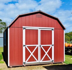 American style wooded shed. A shed is typically simple, single-story roofed structure in a back garden or on an allotment that is used for storage, hobbies, or as a workshop. Exterior view