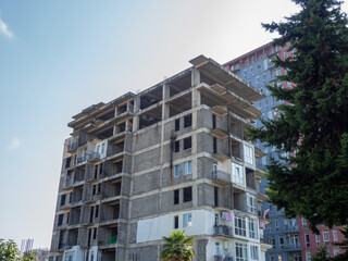 High-rise construction. Skyscraper under construction. Housing frame. Multi-apartment housing. Building cranes. Batumi.