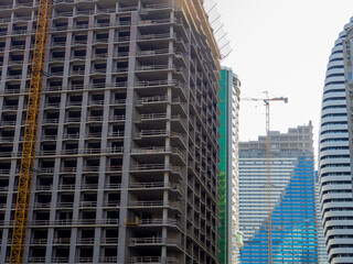 High-rise construction. Skyscraper under construction. Housing frame. Multi-apartment housing. Building cranes. Batumi.