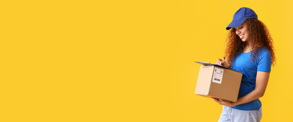Female African-American courier with parcel on yellow background with space for text