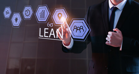 Businessman using virtual screen on dark background. 6 sigma concept