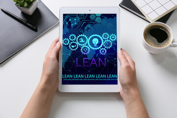 Woman with tablet computer in office. 6 sigma concept