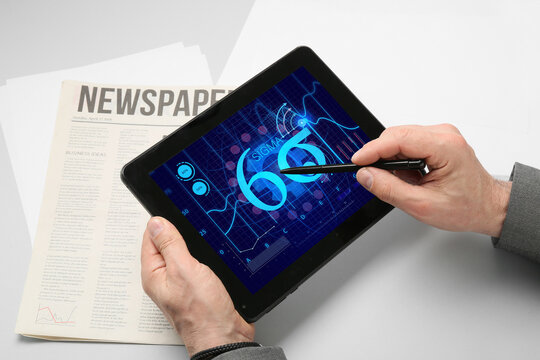 Businessman with tablet computer in office. 6 sigma concept