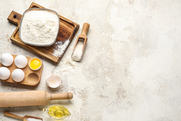 Ingredients for baking and rolling pin on light background