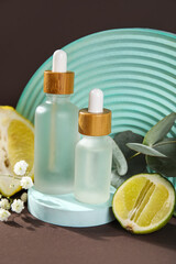 Composition with bottles of essential oil and plaster decor on dark background, closeup