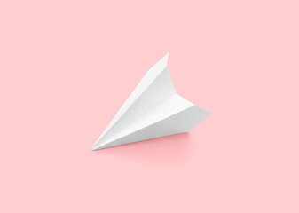 White paper plane on pink background