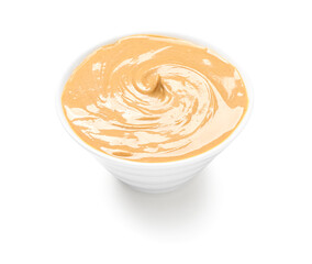 Bowl of tasty nut butter on white background