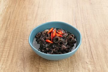 Squid Black Soup (Tumis Cumi Hitam) or stir-fried squid in black ink, Indonesian traditional food
