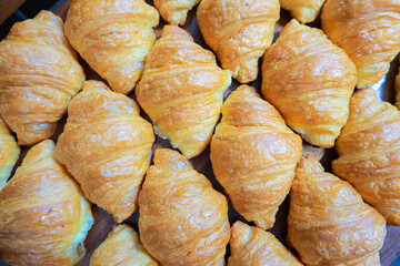 Fresh croissant on wooden table for morning breakfast