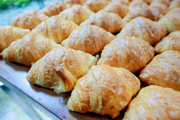 Fresh croissant on wooden table for morning breakfast