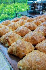 Fresh croissant on wooden table for morning breakfast