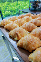 Fresh croissant on wooden table for morning breakfast