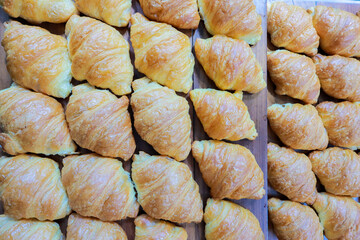 Fresh croissant on wooden table for morning breakfast