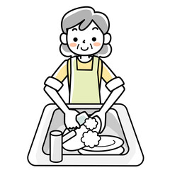 エプロンを着けて食器洗いをするシニア女性