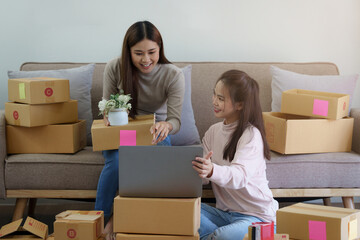 Fototapeta na wymiar Two Asian SME business woman working at home office. online shopping concept