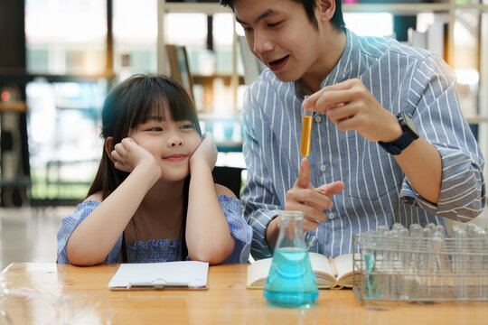 Kid and father doing science experiments. Education science concept