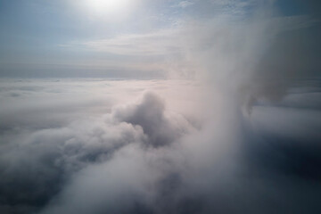 Aerial view from high altitude of earth covered with puffy rainy clouds forming before rainstorm