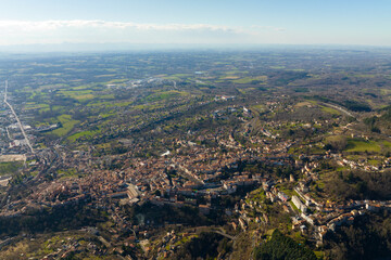 Fototapeta premium Aerial view of dense historic center of Thiers town in Puy-de-Dome department, Auvergne-Rhone-Alpes region in France. Rooftops of old buildings and narrow streets