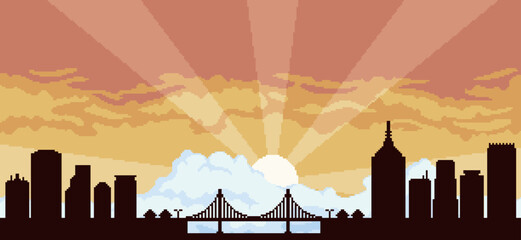Obraz premium Pixel art city ​​background at sunset with buildings, constructions, bridge and cloudy sky for 8bit game