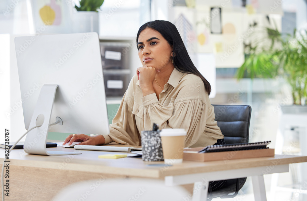 Wall mural Thinking, attention and business woman on computer working by desk in design company office building. Idea, vision and innovation with employee reading email or looking at work online