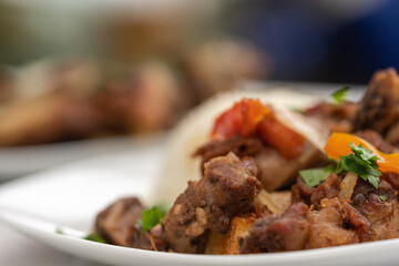 Cropped photo of a dish with guinea pig meat on a table
