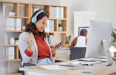 Employee, on phone and headphones in office listening to music while browsing social media. Happy and excited business woman with smile receives good news on her mobile device in corporate building