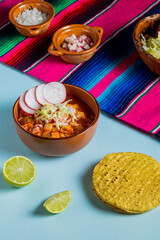 clay dish with red pozole, Mexican national holidays with Mexican food, accompanied by toast, september 16