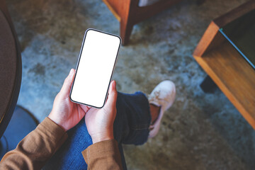 Top view mockup image of a woman holding and touching on mobile phone with blank screen