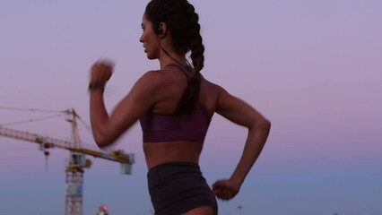 Energy, speed and fitness training by athlete running at sunset, serious and focus on health goals. Young woman doing an intense cardio run, practice endurance and strength, tough physical challenge