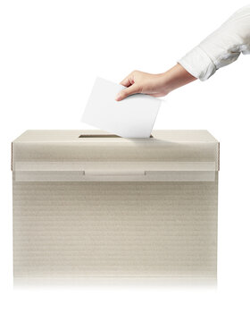 Close-up hand holding ballot paper into the voting box. Freedom democracy concept. Freedom vote concept.