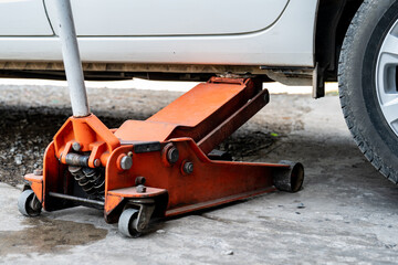 Fototapeta premium close up to the Fixing of broken tire with white car in Thailand local garage.