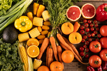 Overhead view of various fruits, vegetables and bell peppers on table